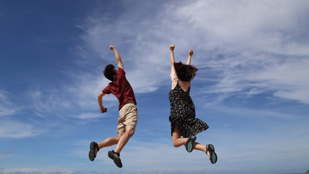 Two people jumping in the clouds